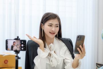 Young Asian woman as vlogger or blogger attending video conference.