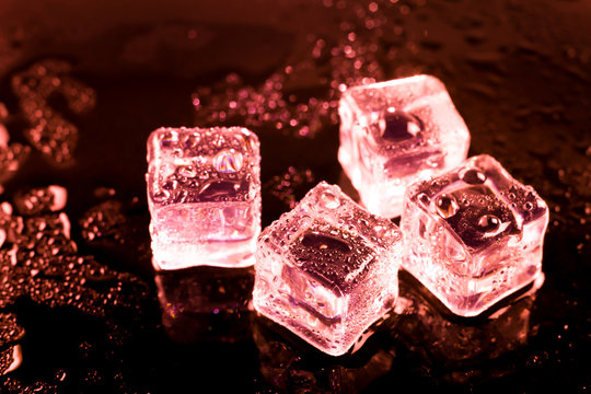 Red Ice Cubes And Water Drop Background.