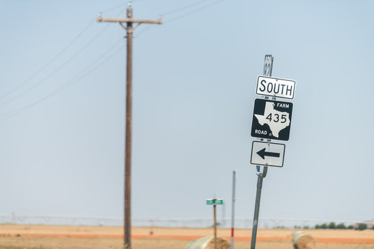 Plains, USA Texas countryside industrial town road and sign for south 435 historic farm road direction arrow view from 380 highway - Powered by Adobe