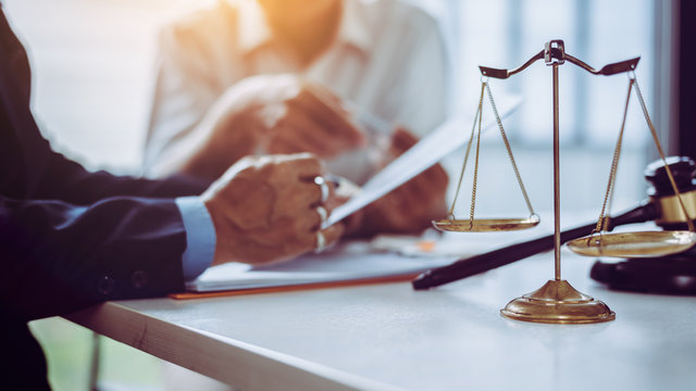 Group of middle age Asian business people and lawyers discussing and sign a contract.