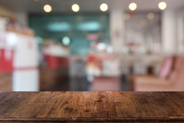 Naklejka na ściany i meble Empty dark wooden table in front of abstract blurred bokeh background of restaurant . can be used for display or montage your products.Mock up for space.