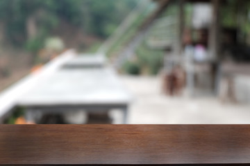 Empty dark wooden table in front of abstract blurred bokeh background of restaurant . can be used for display or montage your products.Mock up for space.