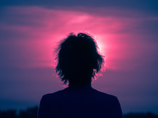 girl looking at the sunset in nature
