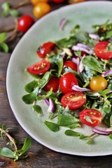 salad with purslane and cherry tomatoes.  concept of organic food from the environment. edible weeds and grass. Purslane is a useful herb. eat the weeds, wild food, eat wild food, wild greens