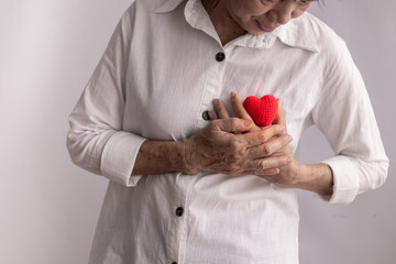 asian elderly woman hold red heart shape, concept of heart disease. © awaygy