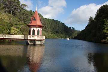 pretty gazebo sitting on the end of the jetty over the lake
