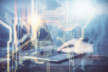 Multi exposure of world map hologram with man working on computer on background. Concept of worldwideweb.