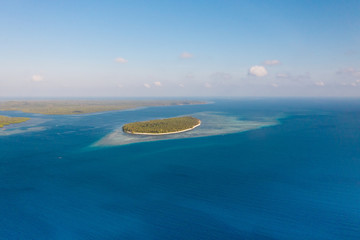 Fototapeta na wymiar Large islands located on the atolls, a top view. Island with forest.