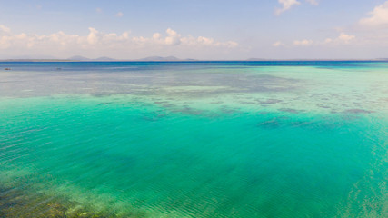 Coral reefs and atolls in the tropical sea, top view. Turquoise sea water and beautiful shallows. Philippine nature.