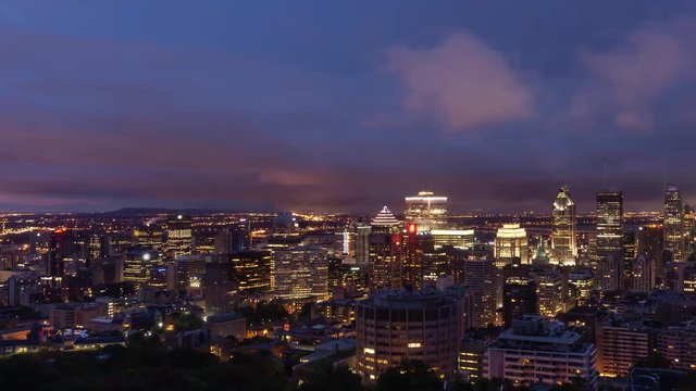 Aerial Time Lapse of a beautiful modern downtown city during a striking cloudy sunrise. Taken in Mt Royal, Montreal, Quebec, Canada.
