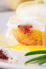 Breakfast is Eggs Benedict - toasted English muffins, bacon, ham, poached eggs, herbs and delicious buttery hollandaise sauce.