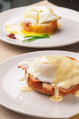 Breakfast is Eggs Benedict - toasted English muffins, bacon, ham, poached eggs, herbs and delicious buttery hollandaise sauce.