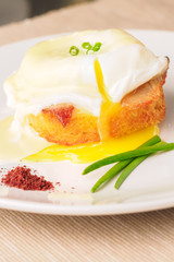 Breakfast is Eggs Benedict - toasted English muffins, bacon, ham, poached eggs, herbs and delicious buttery hollandaise sauce.