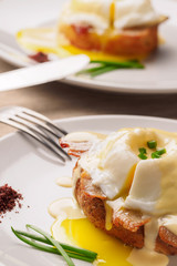 Breakfast is Eggs Benedict - toasted English muffins, bacon, ham, poached eggs, herbs and delicious buttery hollandaise sauce.