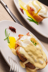 Breakfast is Eggs Benedict - toasted English muffins, bacon, ham, poached eggs, herbs and delicious buttery hollandaise sauce.