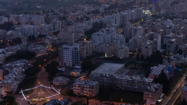 Aerial Time Lapse of a residential neighborhood in a city during a vibrant and colorful sunrise. Taken in Netanya, Center District, Israel.