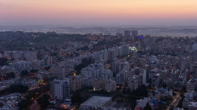 Aerial Time Lapse of a residential neighborhood in a city during a vibrant and colorful sunrise. Taken in Netanya, Center District, Israel.