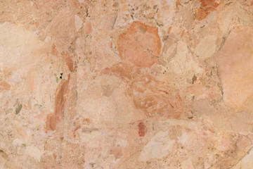 background of old cracked natural marble of red, yellow color with spots of different size and color