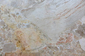 background of old cracked natural marble of red, yellow color with spots of different size and color