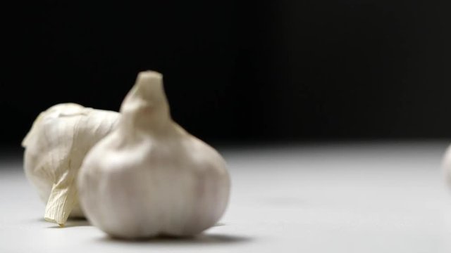 Whole garlic bulbs falling in slow motion