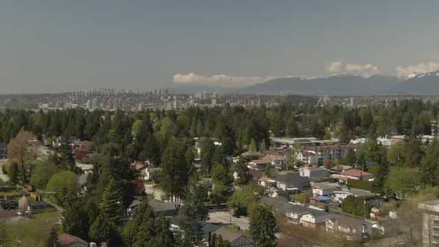 Aerial view of residential homes near Surrey Central Mall during a sunny day. Taken in Greater Vancouver, British Columbia, Canada.