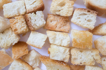 Pieces of roasted white bread . Close-up of delicious croutons.