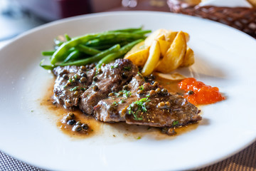 Beef steak with mushroom sauce and roasted potatoes 