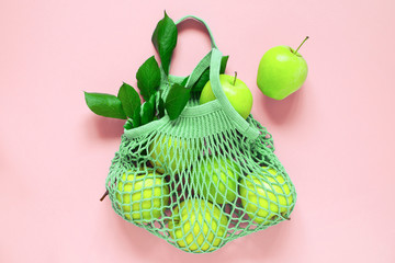 Green mesh bag with fresh apples