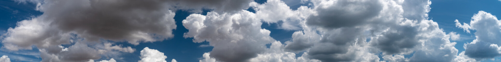 white clouds float across the blue sky