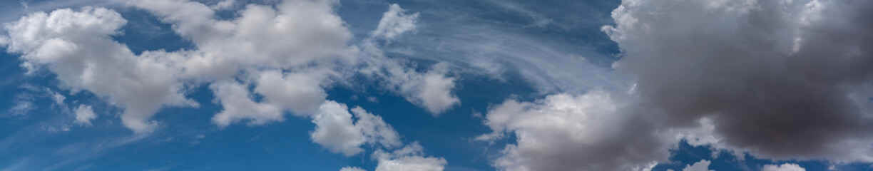 white clouds float across the blue sky