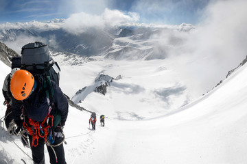 A group of mountain climbers climb up to Iiktu Peak. South Chuya Mountain Range, Altai Republic, Siberia, Russia.