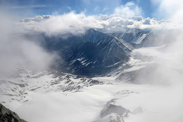 Fototapeta premium Cloudy mountainous landscape. View at South Chuya Mountain Range from slope of IIktu Peak. Altai Republic, Siberia, Russia.