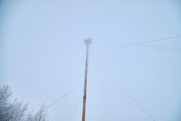 Technical tower in fog and snow in winter