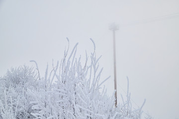 Technical tower in fog and snow in winter