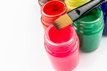 Multicolored bottles poster color and paintbrush  on a white background Isolated Paints in...