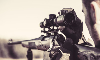 Hunter man. Hunting period. Close up. Hunter with hunting gun and hunting form to hunt. Hunter is...