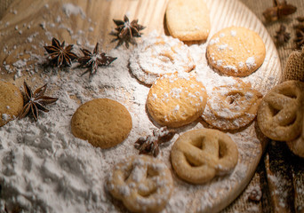 Sweet Biscuits on cutting board and canvas with powder on wooden table, vintage style. Royalty high quality free stock image.