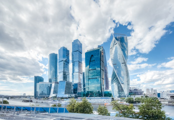 Obraz premium Business center of Moscow city under a blue sky with cumulus clouds on a summer day