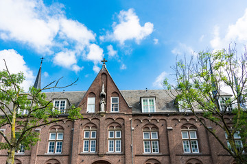 facade of historical building, with sculpture and towers, in Woerden, The Netherlands