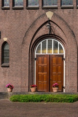 Fototapeta na wymiar Wooden doors of Opstandingskerk, church in Woerden, The Netherlands