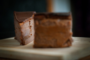 Burnt chocolate cheesecake on brown wooden background. selective focus