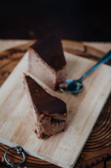 Burnt chocolate cheesecake on brown wooden background. selective focus
