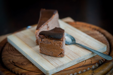 Burnt chocolate cheesecake on brown wooden background. selective focus