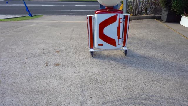 white and red circle head robot moves to right frame and spins head close up. Filmed at Australia, Queensland, Sunshine Coast, Maroochydore. Filmed with Sony A7 Mark 3.