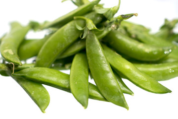 Closeup pile of fresh green beans isolated  on a white background