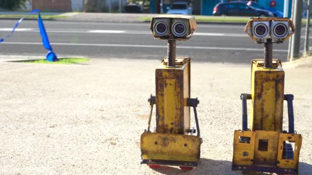 slow pan of yellow industrial robots sci fi medium shot. Filmed at Australia, Queensland, Sunshine Coast, Maroochydore
