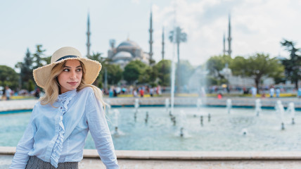 Beautiful girl poses in front of Mosque