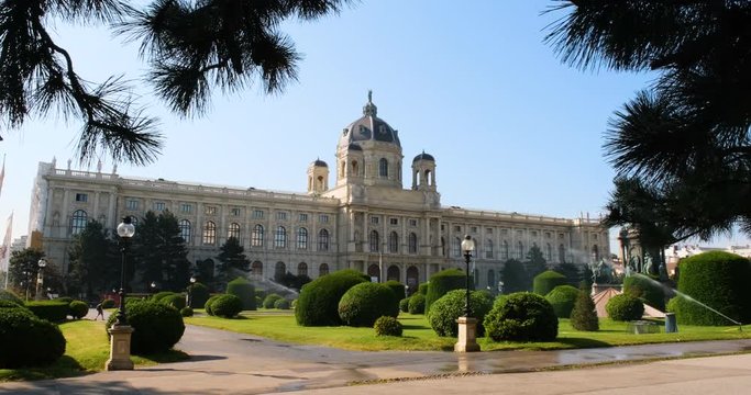 Art and History Museum in Vienna early in the morning on a clear Sunny summer day. water watering the garden at the entrance to the Museum