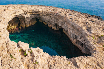 Big natural hole in the rock. Coral Lagoon. Malta island - obrazy, fototapety, plakaty