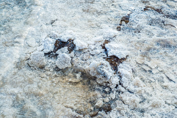 Crystals of natural salt in the lifeless hot terrain on the salt lake Baskunchak.